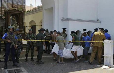 Sri Lankans carried a victim?s body out of St. Anthony?s Church in Colombo after the explosions.
