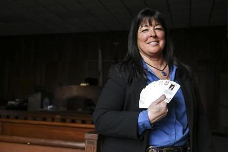 Pawtucket police Detective Susan Cormier said a byproduct of the playing cards is a statewide task force on cold cases.
Pawtucket Detective Susan Cormier held a deck of playing cards that each feature an unsolved case across Rhode Island.
