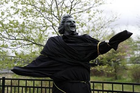 A partially covered statue of singer Kate Smith is seen near the Wells Fargo Center, Friday, April 19, 2019, in Philadelphia. The Philadelphia Flyers covered the statue of singer Kate Smith outside their arena, following the New York Yankees in cutting ties and looking into allegations of racism against the 1930s star with a popular recording of 