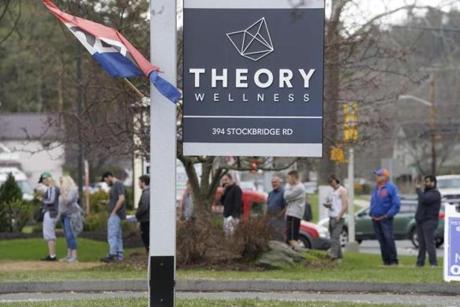 A long line leads all the way to the roadway at Theory Wellness in Great Barrington, Mass., one of the Berkshire's recreational marijuana retailers, on the Eve 420, Friday April 19, 2019. (Ben Garver/The Berkshire Eagle via AP)
