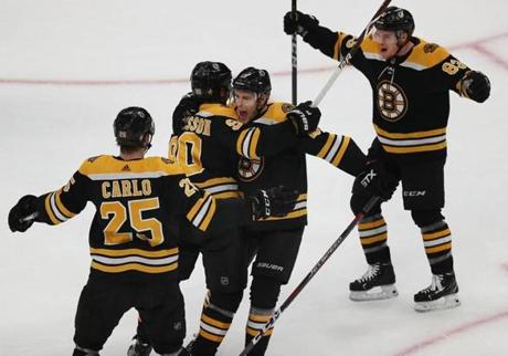 Boston-04/23/2019 The Boston Bruins vs Toronto Maple Leafs game 7- Bruins Marcu Johansson(left center) is hugged by Charlie Coyl affter Johansson's 1st period goal to put the Bruins up, 2-0. Brandon Carlo(left) and Karson Kuhlman join in. Photo by John Tlumacki/Globe Staff(sports)
