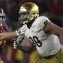 Notre Dame defensive lineman Jerry Tillery, right, runs a play against Southern California guard Chris Brown during the second half of an NCAA college football game Saturday, Nov. 24, 2018, in Los Angeles. Notre Dame won 24-17. (AP Photo/Mark J. Terrill)