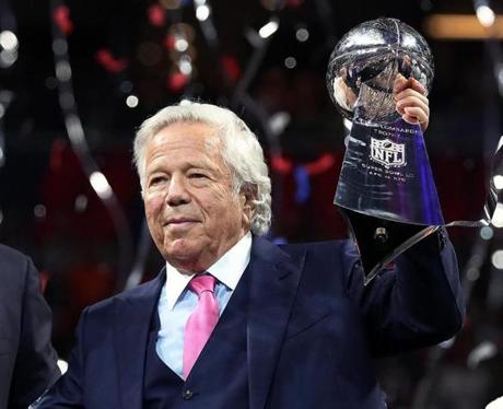 02-03-19: Atlanta, GA: New England Patriots owner Robert Kraft (right) is pictured on the podium with the Lombardi Trophy during the post game celebration following the team's Super Bowl victory. NFL Commissioner Roger Goodell is at left. The New England Patriots met the Los Angeles Rams in Super Bowl LIII at Mercedes-Benz Stadium. (Jim Davis /Globe Staff)
