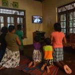 A Catholic family at home near St. Sebastian's Church in Negombo followed a TV service conducted by the Archbishop of Colombo, Cardinal Malcolm Ranjith on Sunday.