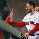 4-30-19: Boston, MA: After he scored on Mitch Moreland's bottom of the fourth inning two run home run, Red Sox rookie Michael Chavis got a hand from veteran teammate Dustin Pedroia (left). The Boston Red Sox hosted the Oakland Athletics in a regular season MLB baseball game at Fenway Park. (Jim Davis /Globe Staff).