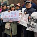 Advocates and residents, both current and former, of Chinatown?s Maple Place and Johnny Court, demonstrated Tuesday in an effort to protect historic row houses from developers. 