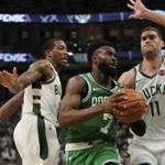 Boston Celtics' Jaylen Brown drives past Milwaukee Bucks' Eric Bledsoe and Brook Lopez (11) during the second half of Game 2 of a second round NBA basketball playoff series Tuesday, April 30, 2019, in Milwaukee. The Bucks won 123-102 to tie the series at 1-1. (AP Photo/Morry Gash)